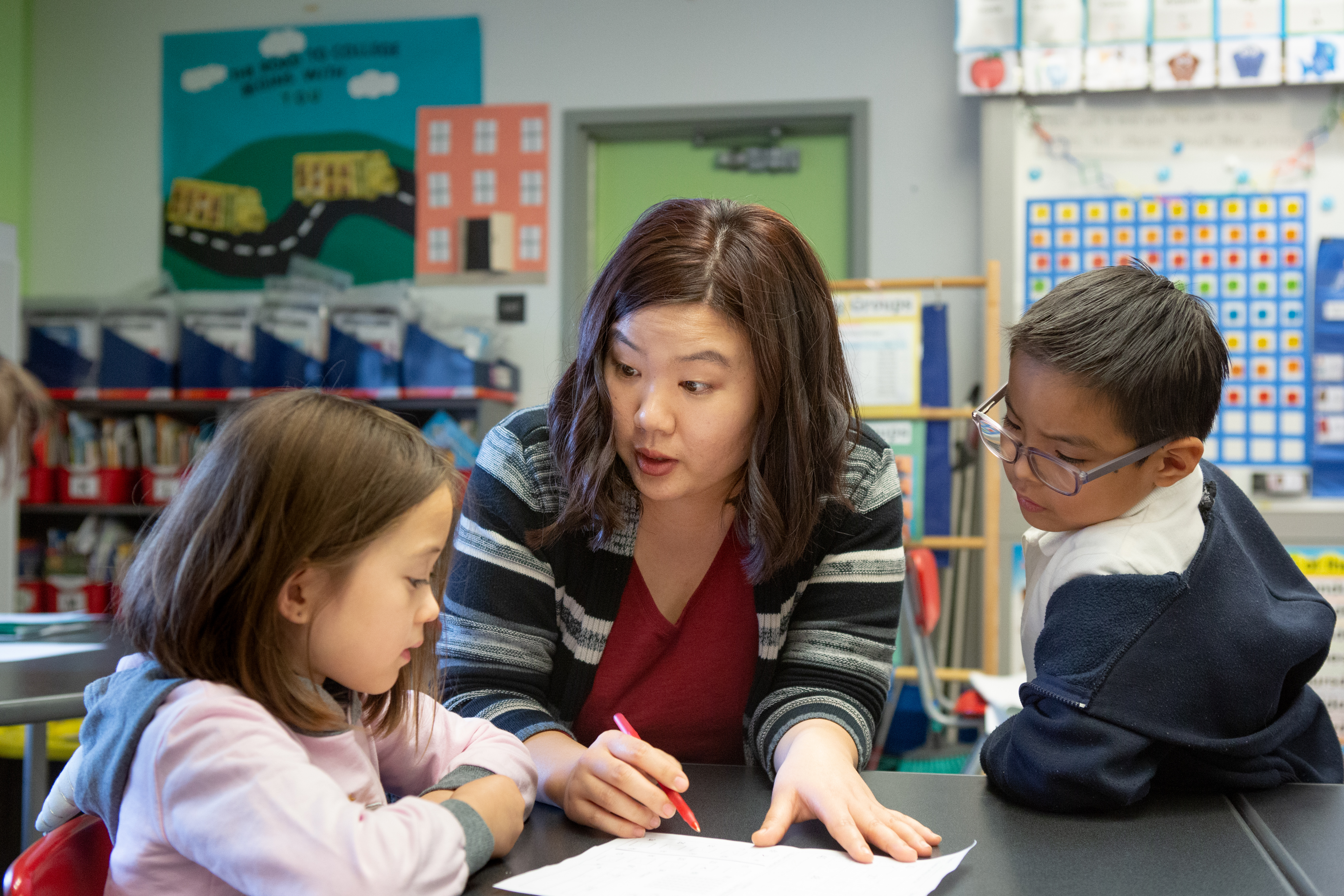 Teacher working with students.